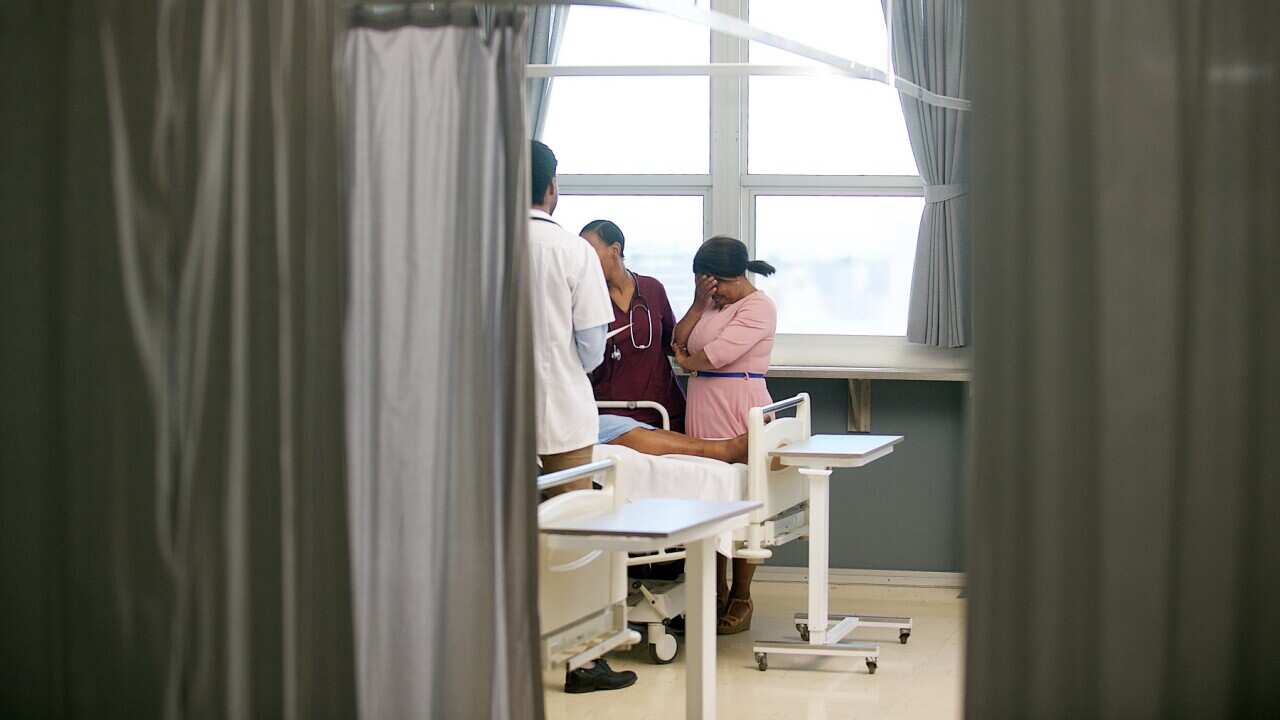 A doctor with family members at a hospital