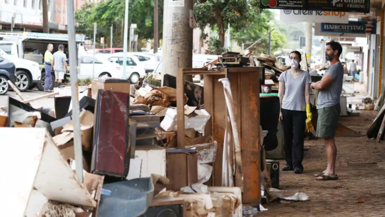 Residents and business owners assess the flood damage in Lismore, NSW. 