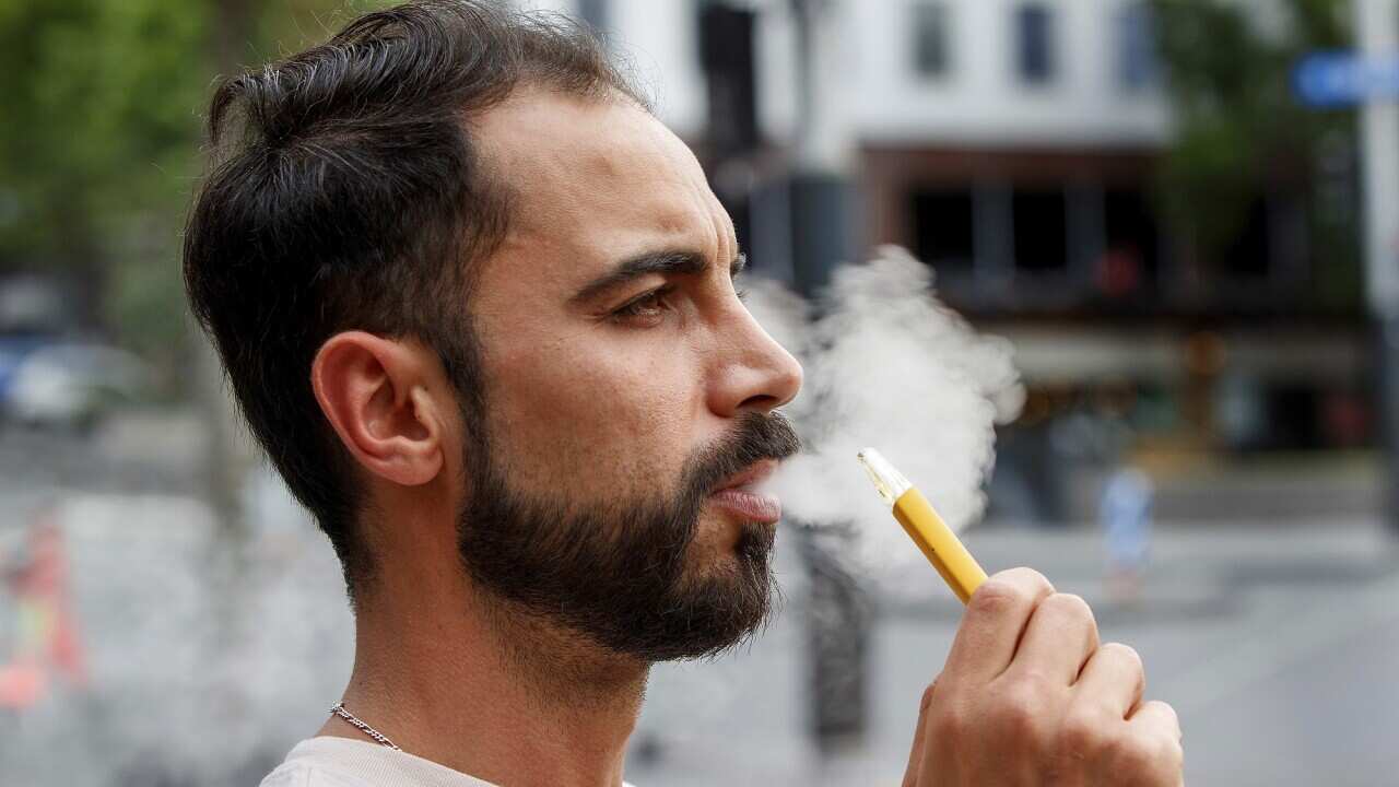 A man uses a vaping product.