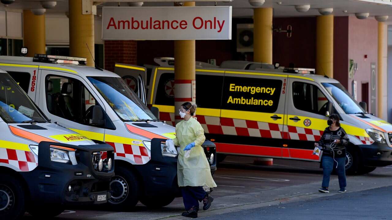 NSW Ambulances park in the receiving bay for the Emergency Department at the Liverpool Hospital in Sydney, Wednesday, September 8, 2021. Medical experts are concerned that hospital emergency departments in NSW will face almost five times the number of COV