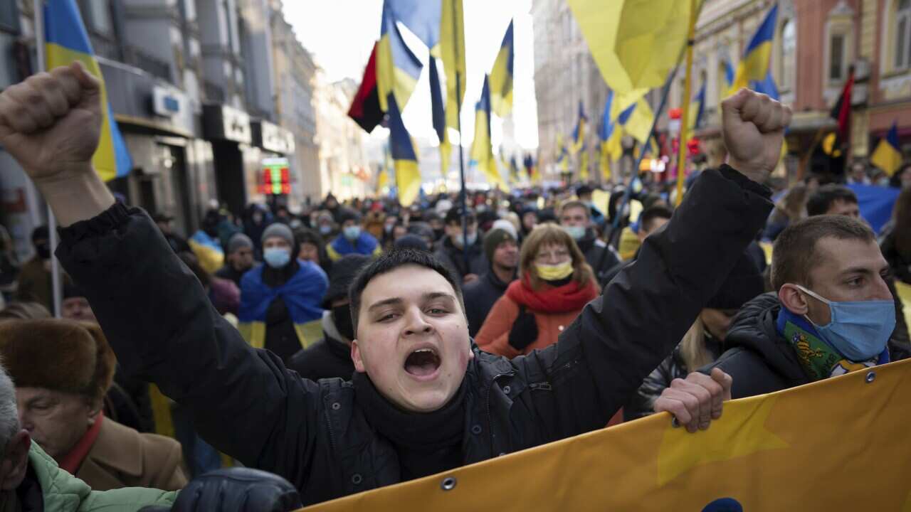 Demonstrators with Ukrainian national flags, one of them shouts, rally against Russian aggression in the centre of Kharkiv