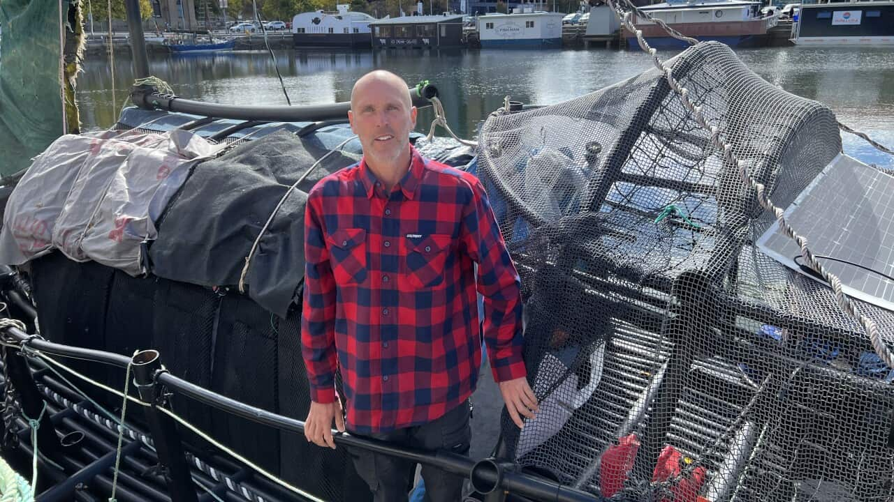 A man stands on a boat.