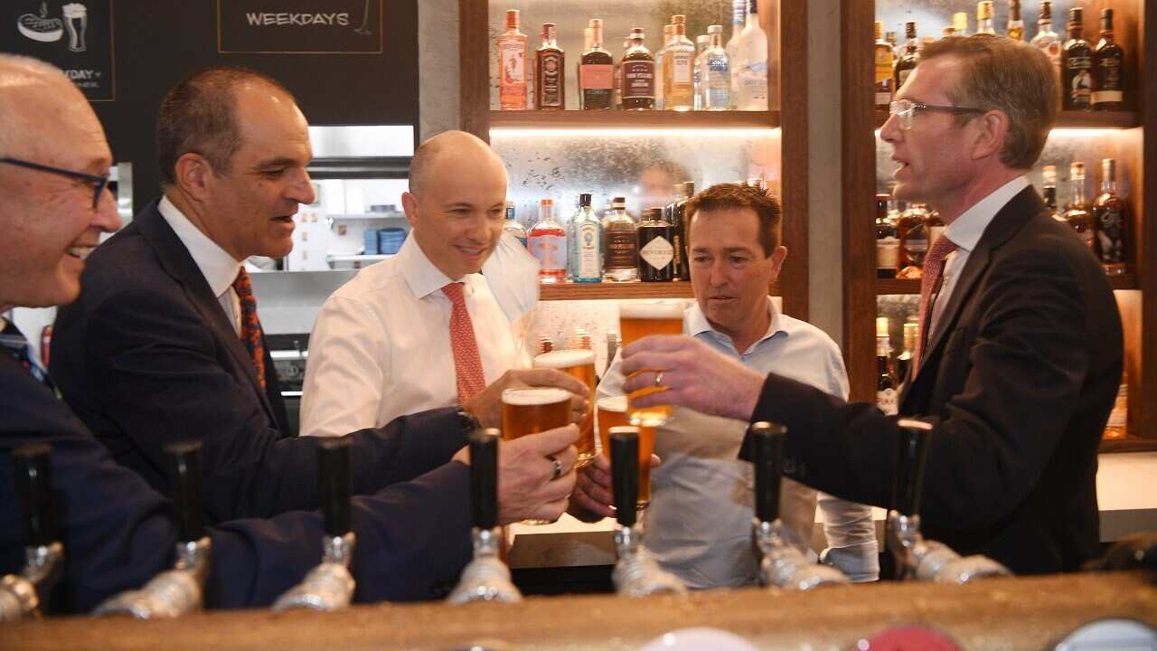 NSW Premier Dominic Perrottet (right) and NSW Deputy Premier Paul Toole (2nd from right) and Treasurer Matt Kean toast with a beer at Watson’s Pub in Sydney