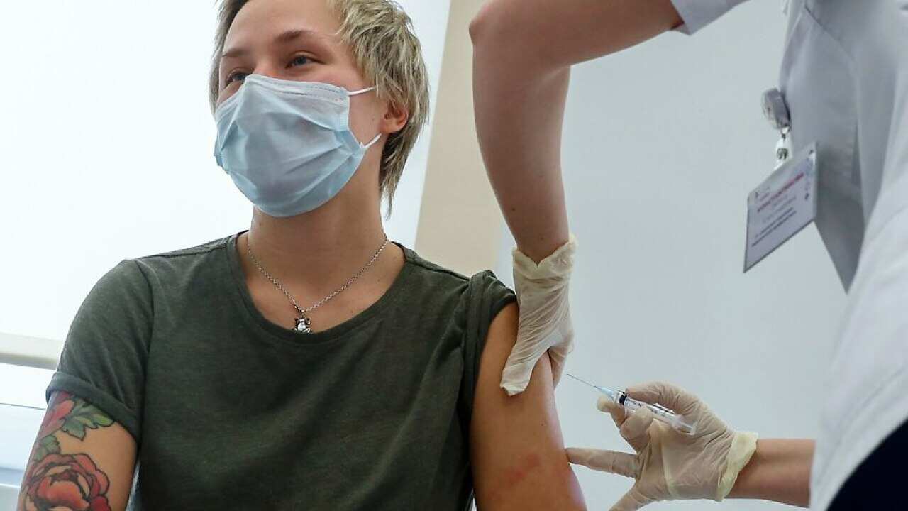 A Russian medical worker administers a shot of Russia's Sputnik V coronavirus vaccine in Moscow on 5 December, 2020