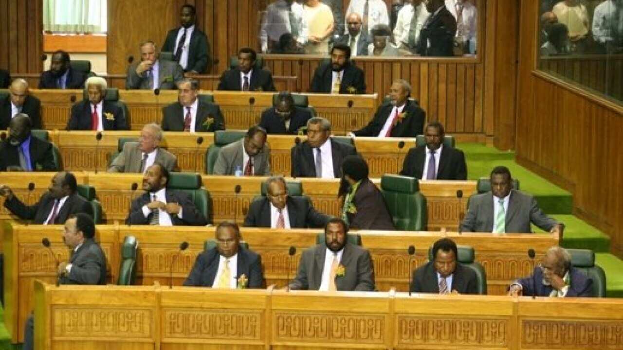 Men in suits sitting in Papua New Guinea's parliament