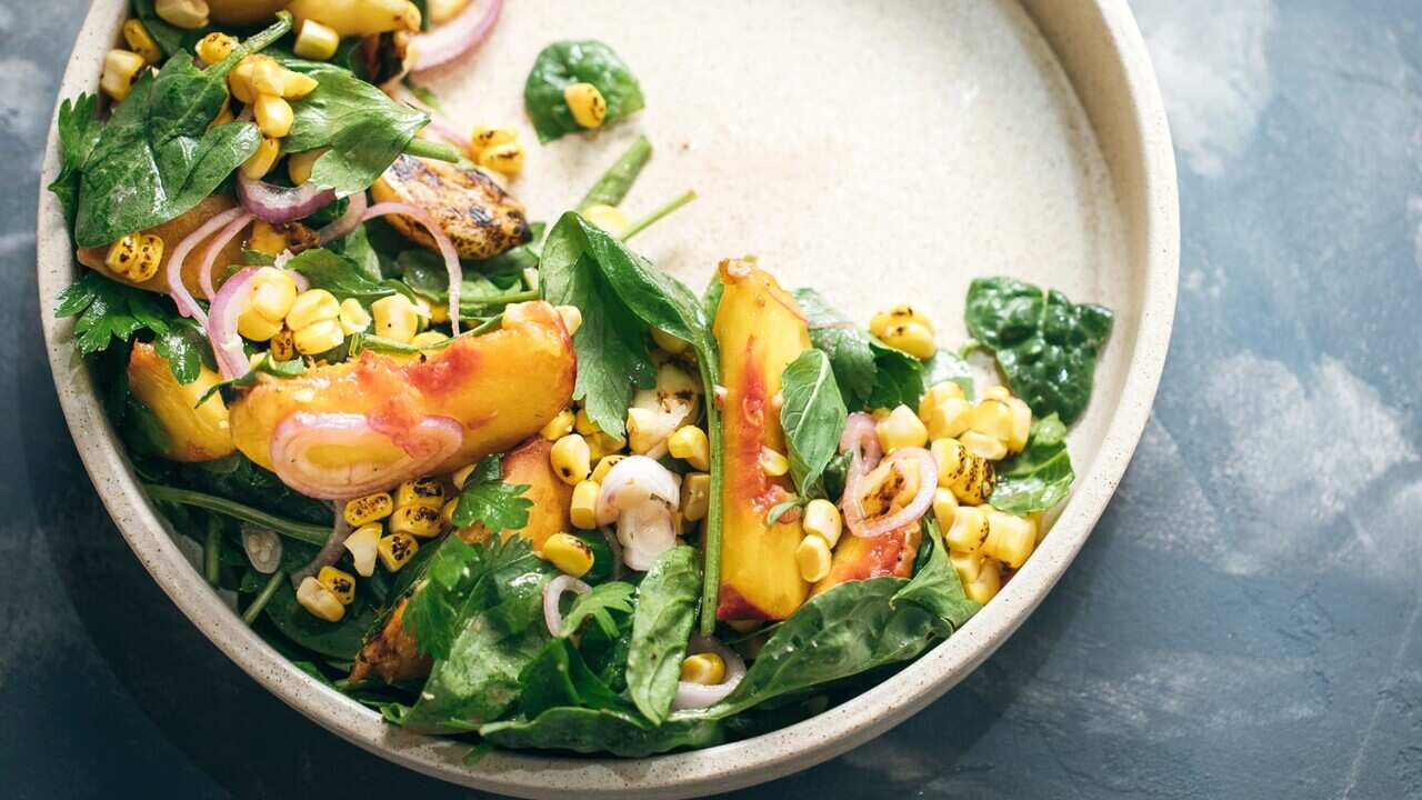 Charred peach, corn and spinach salad