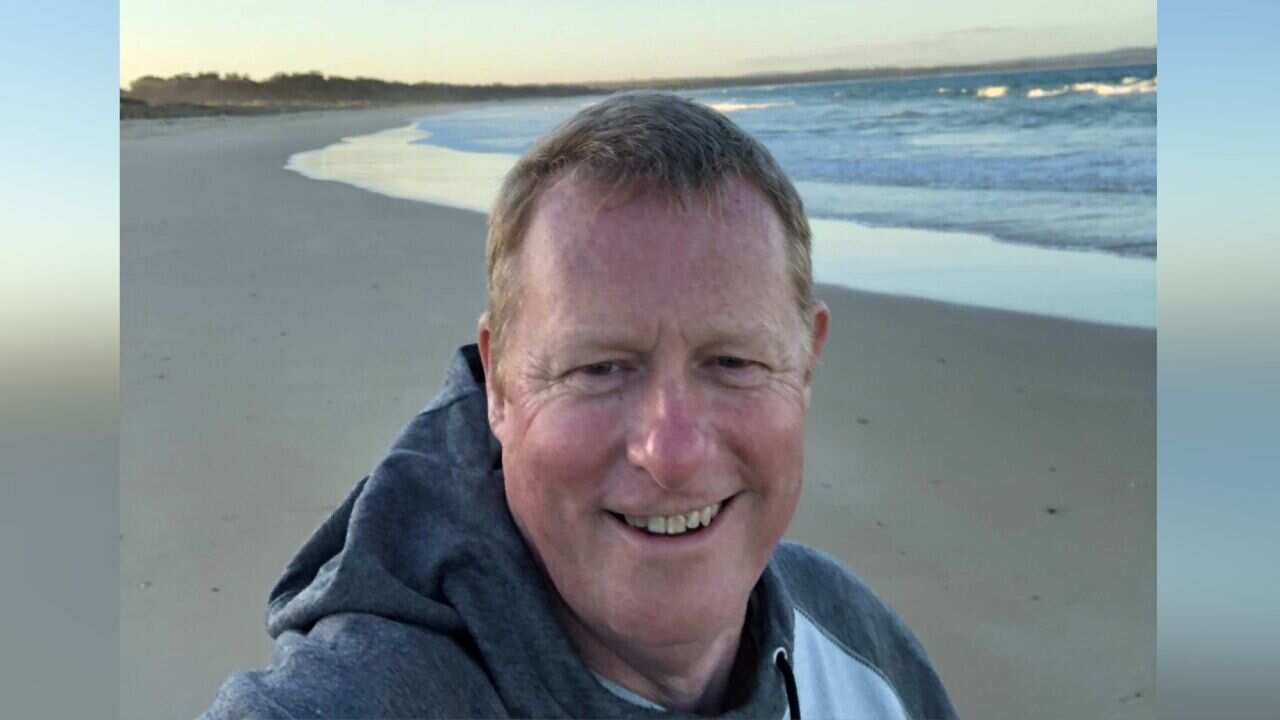 A man taking a selfie at the beach