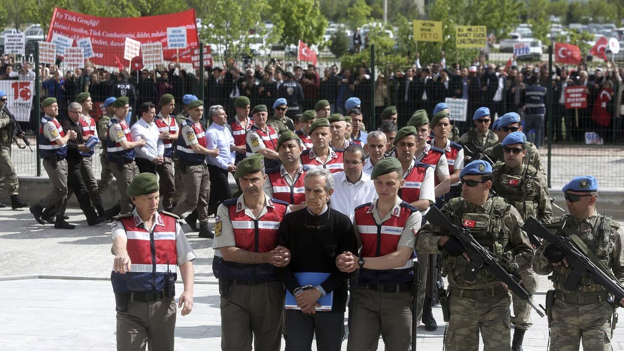 In this Monday, May 22, 2017 file photo, Turkish paramilitary police and army officers escort the alleged instigators of the July 15, 2016 failed military coup