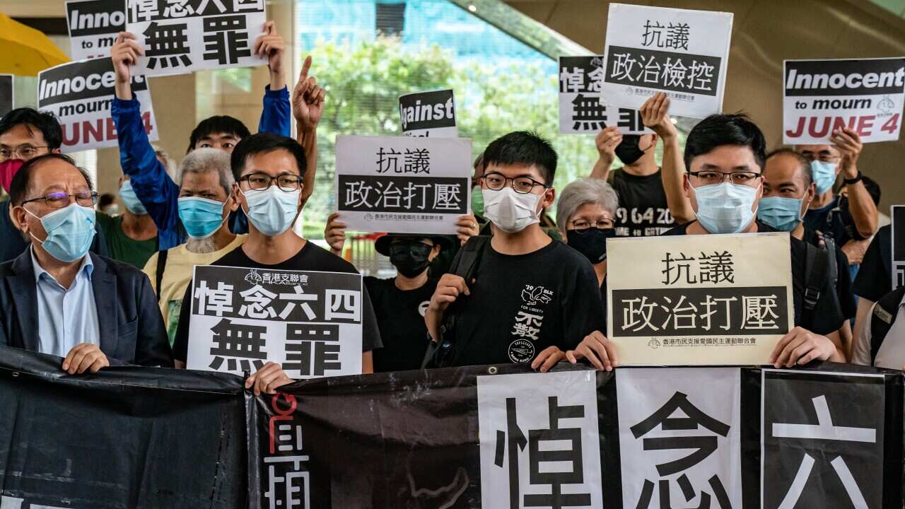 Hong Kong disqualified four opposition members of its legislature on Wednesday for endangering security.