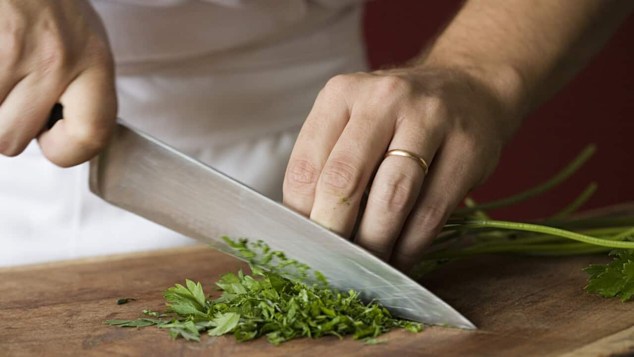 Chef chopping parsley