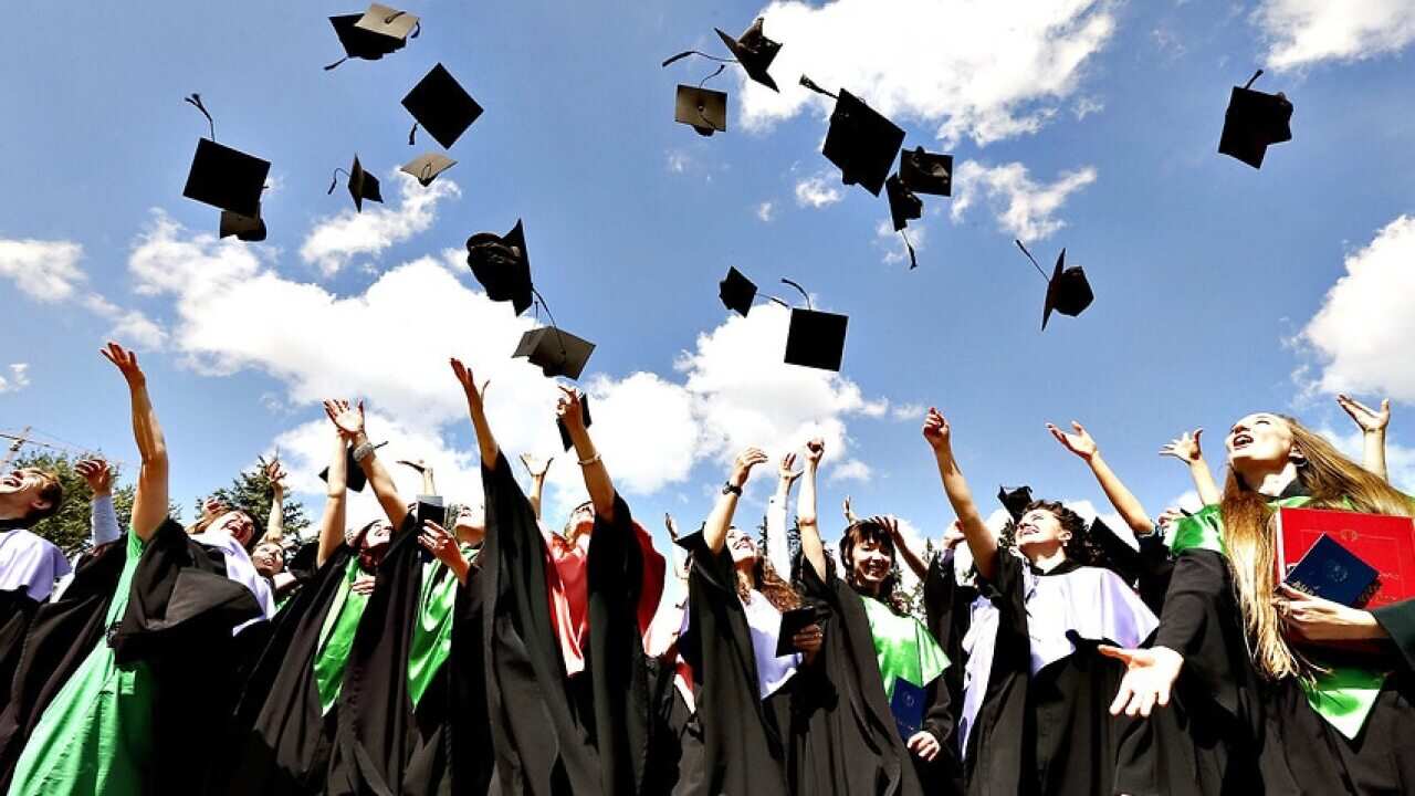 Image of graduates throwing hats