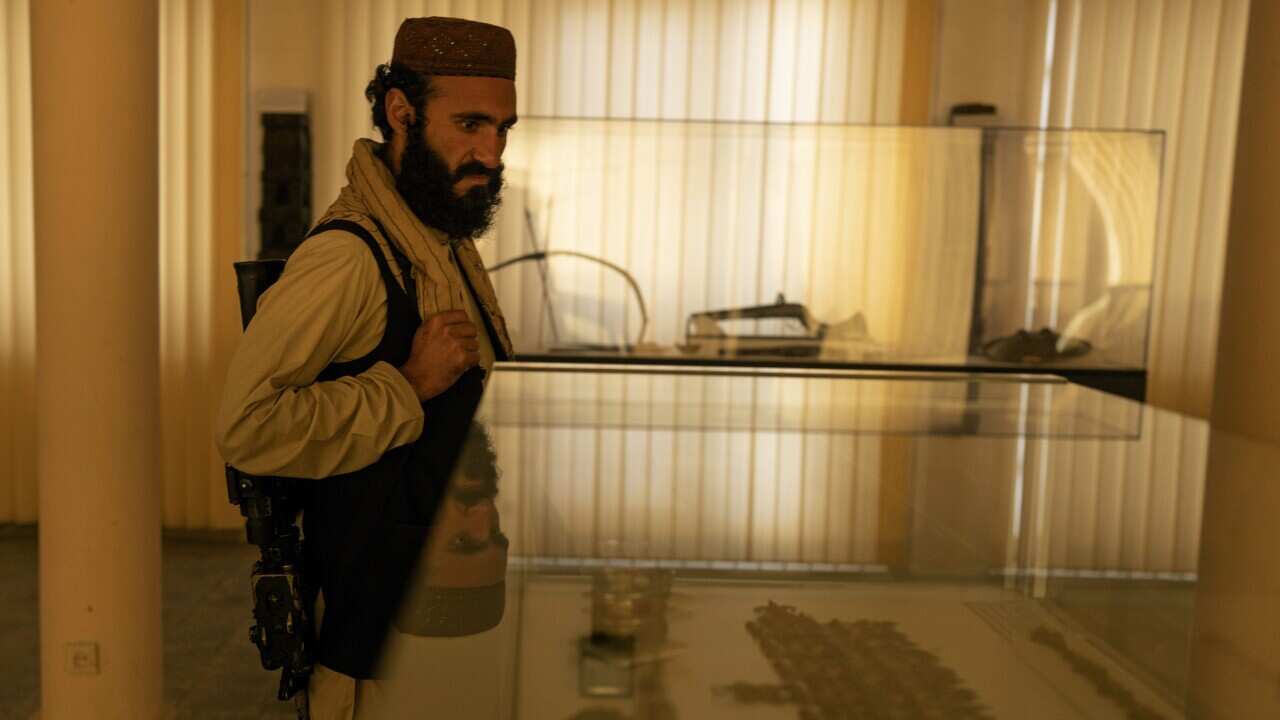 29 year- old Taliban Fighter Mansoor Zulfiqar, left, visits the National Museum of Afghanista