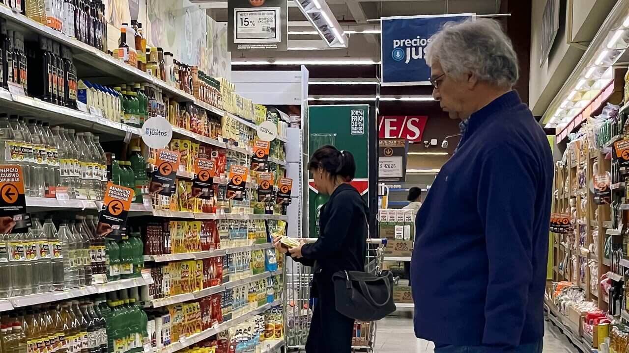 A man stares at produce on a supermarket shelf in Buenos Aires