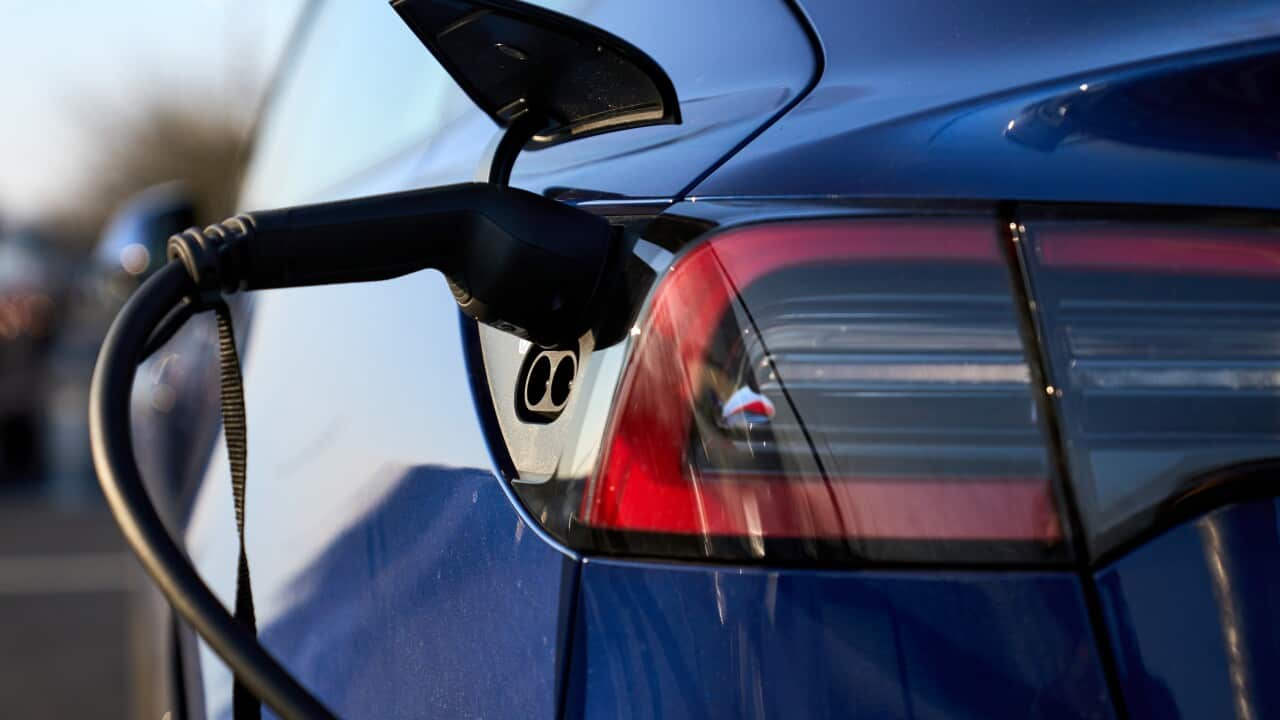 A Tesla electric vehicle being charged.