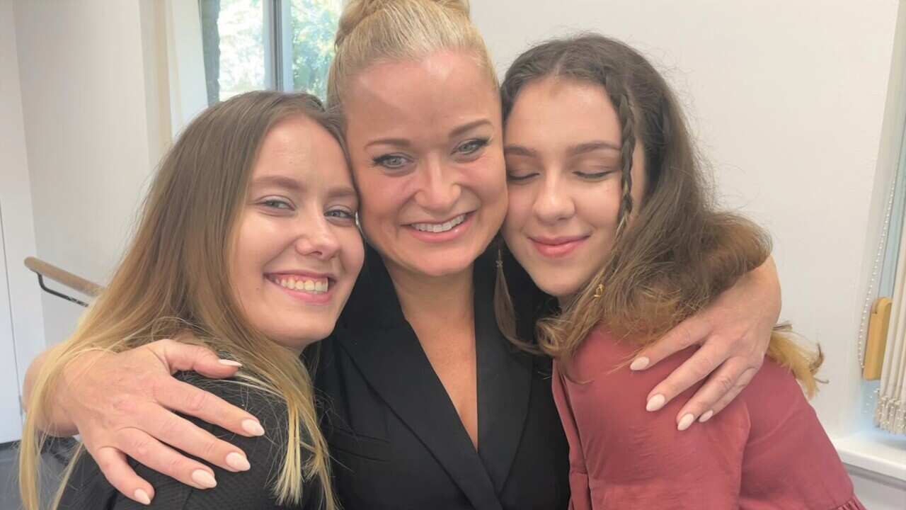 Three women hugging