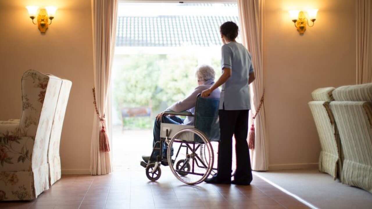 Nurse pushing patient in wheelchair