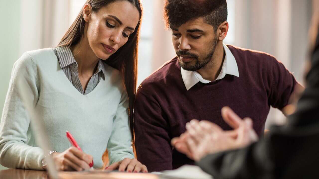 couple signing documents