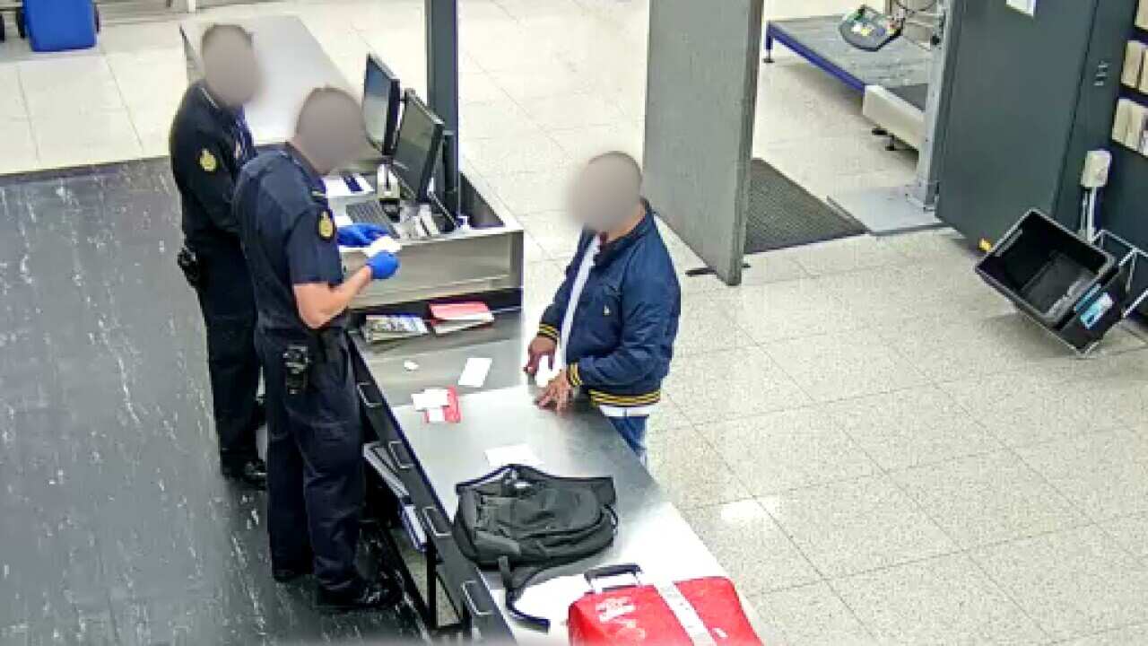 The Brazilian man being questioned by ABF officers at Perth Airport