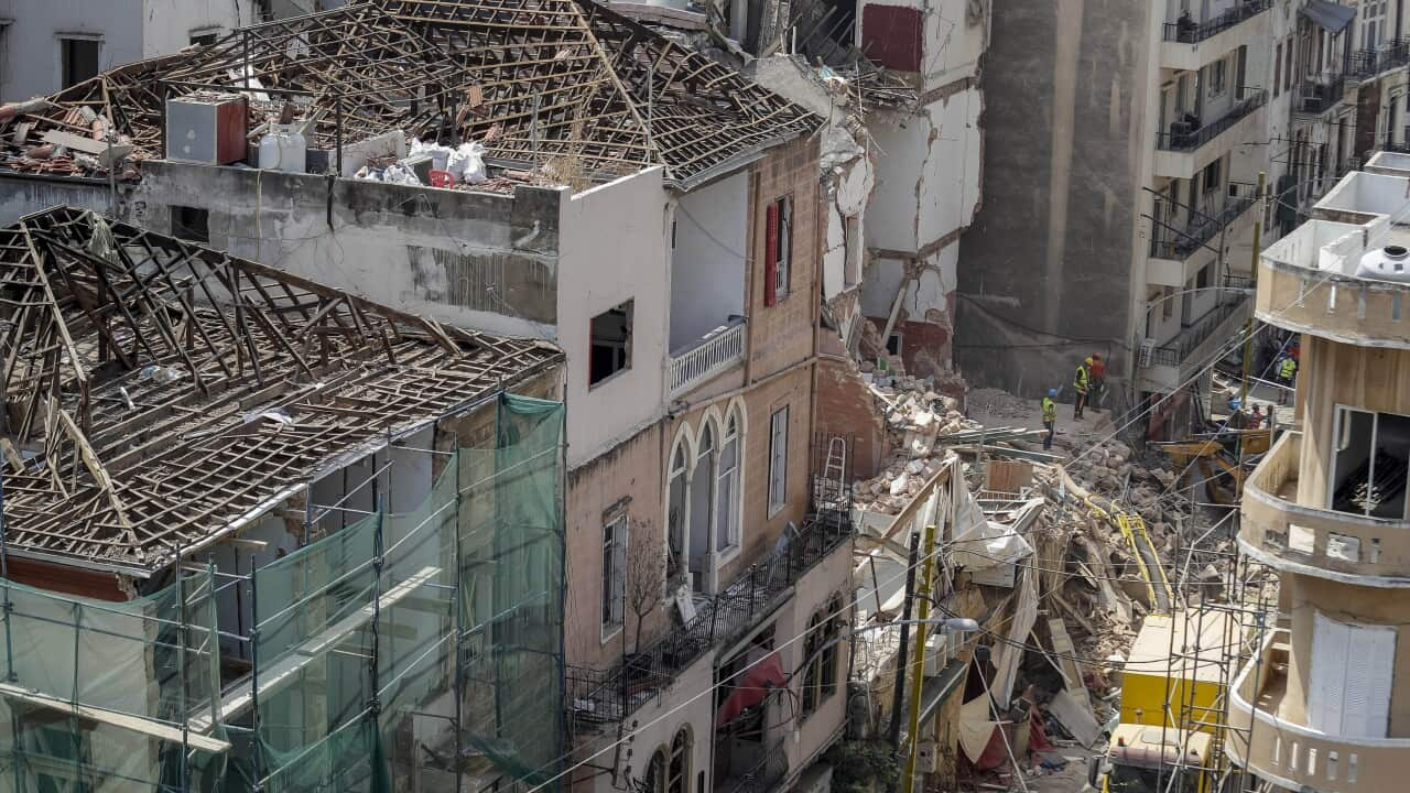 Rescuers search at the site of a collapsed building after getting signals there may be a survivor under the rubble in Beirut, Lebanon.