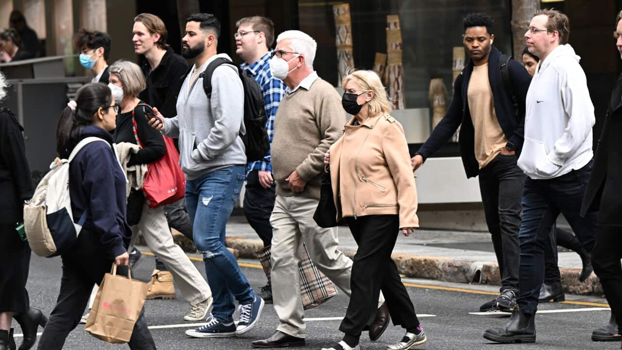 People are seen wearing face mask’s in the CBD of Brisbane, Wednesday, July 20, 2022. Queenslanders are being asked to carry a mask at all times as the state records more than 9600 new COVID-19 cases. (AAP Image/Darren England) NO ARCHIVING