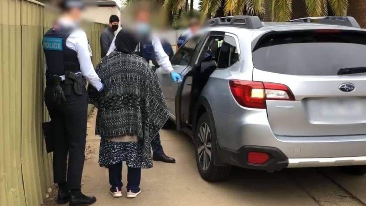 AFP officers arresting a woman charged with forcing someone into a marriage in Shepparton, Victoria