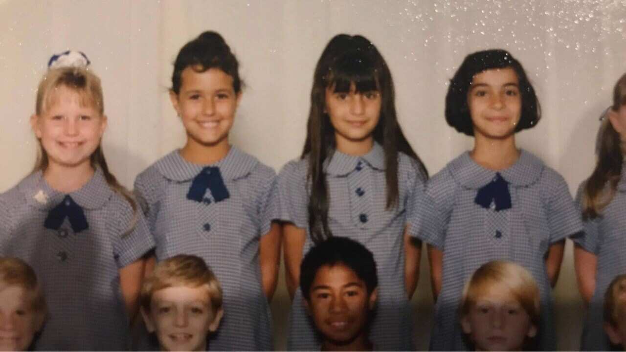 School photo of child with long hair and fringe