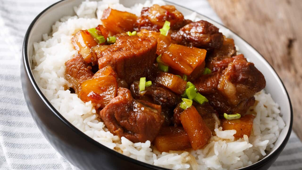 Filipino belly pork hamonado with pineapple and rice close-up. horizontal