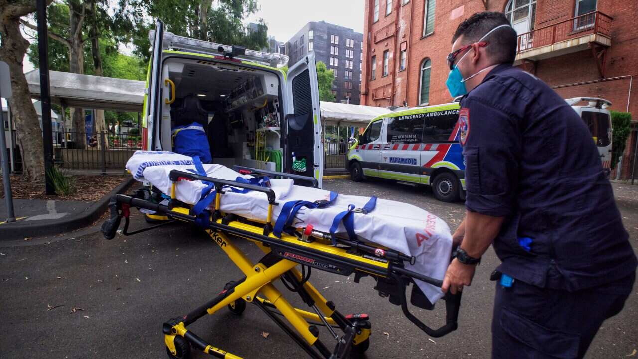 Paramedics tending to their ambulance outside St Vincent hospital in Melbourne. Source: AAP