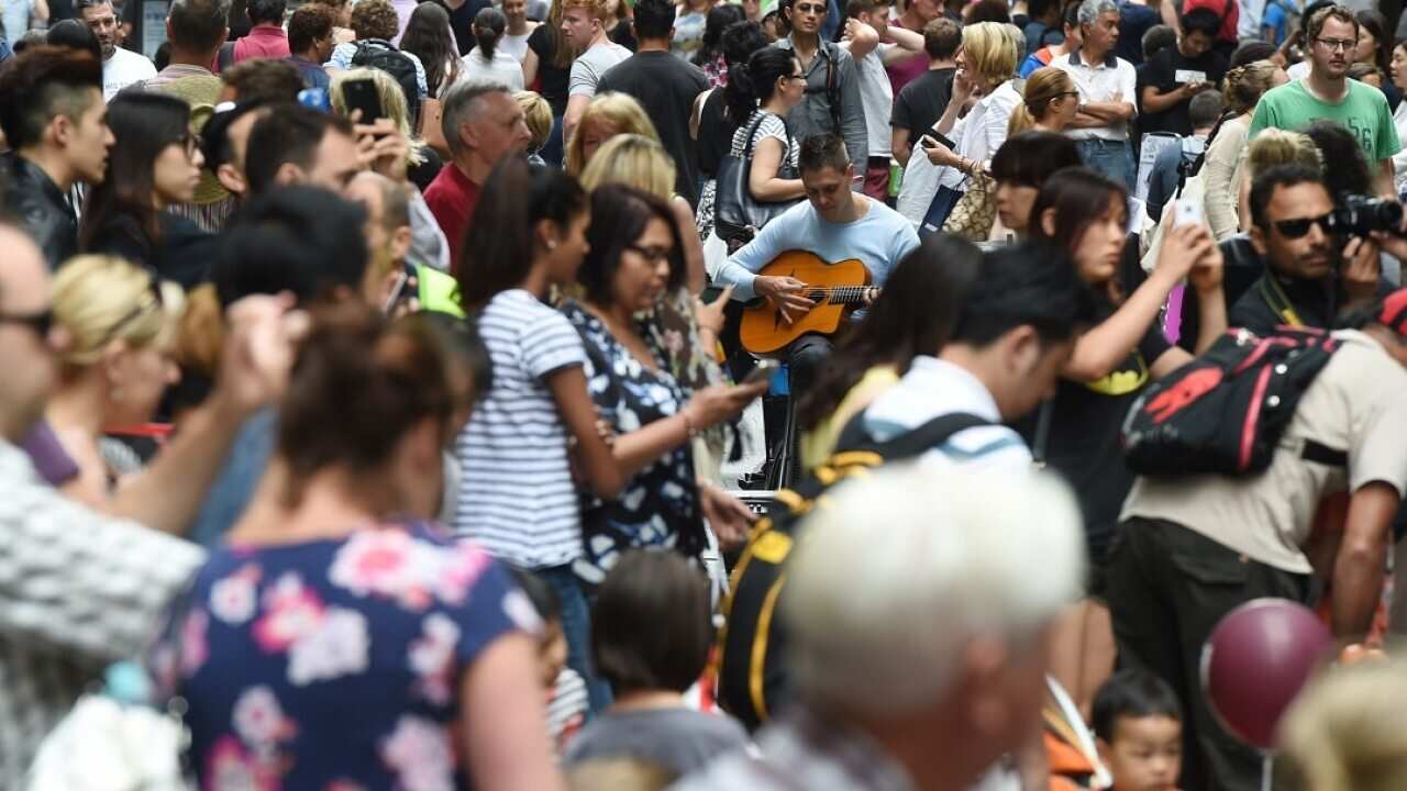 Huge crowds fill Pitt Street Mall and the CBD shopping district as they purchase their last minute christmas gifts on Christmas Eve in Sydney, Wednesday, Dec. 24, 2014. (AAP Image/Dean Lewins) NO ARCHIVING