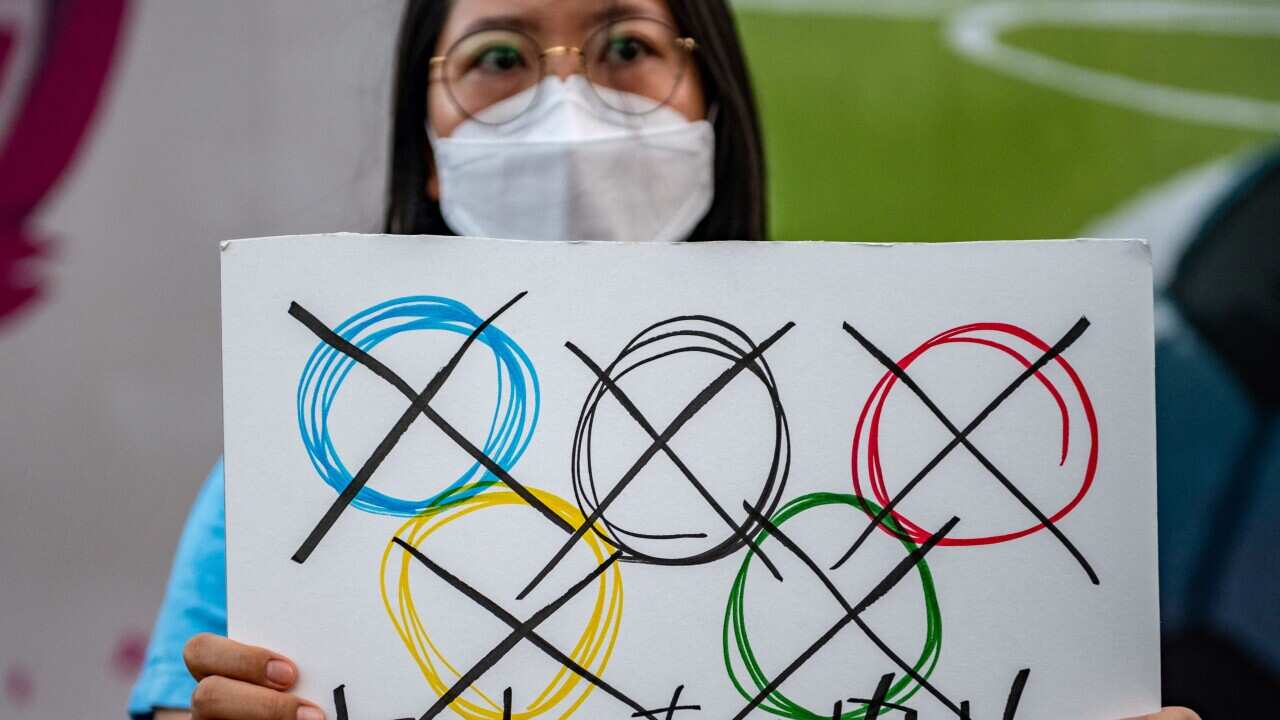 A protestor holds up a sign