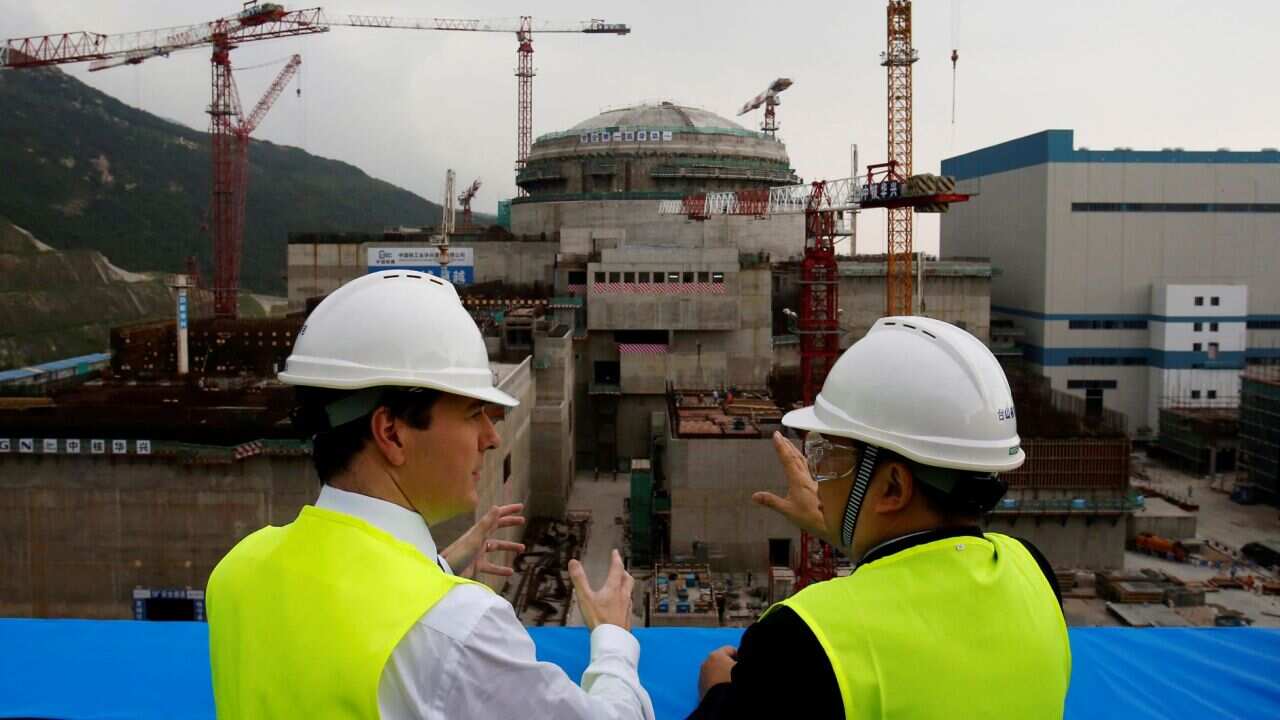 On Oct. 17, 2013, then British Chancellor of the Exchequer George Osborne, left, chats with Taishan Nuclear Power Joint Venture Co. Ltd. General Manager Guo Liming