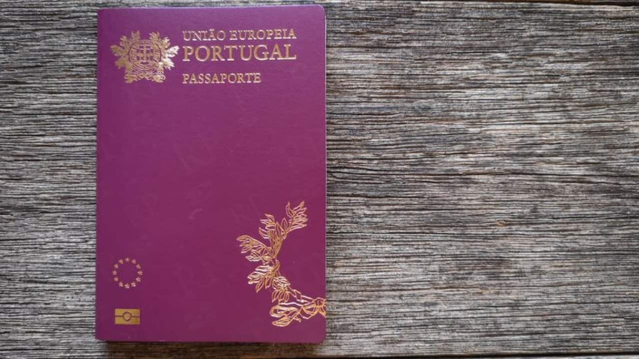 Portuguese passport with wooden background