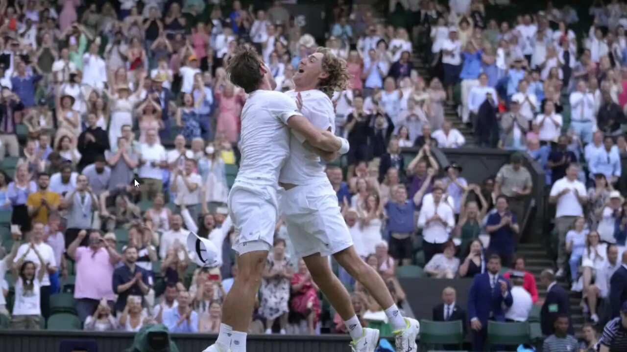 Matthew Ebden (left) and Max Purcell (right) from Australia celebrate after beating Mate Pavic and Nikola Mektic of Croatia to win the final of the men's doubles on day thirteen of the Wimbledon tennis championships in London, Saturday, July 9, 2022.