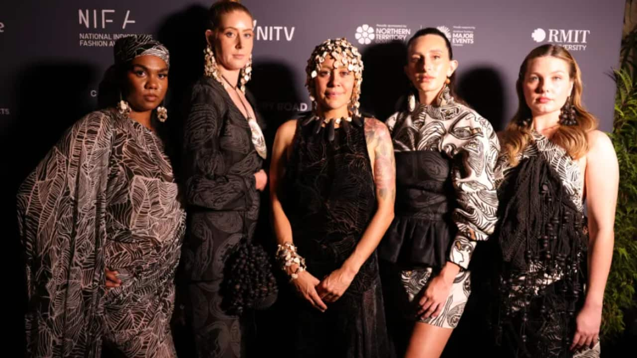 Lillardia Briggs-Houston (center), winner of the Fashion Designer Award at the 2023 National Indigenous Fashion Awards, flanked by models wearing her designs. Source: Marley Morgan Photography