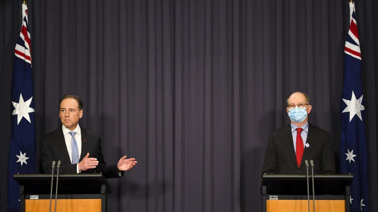 Australian Health Minister Greg Hunt (left) and Australia’s Chief Medical Officer Paul Kelly speak to the media during a press conference at Parliament House in Canberra, Wednesday, October 20, 2021. (AAP Image/Lukas Coch) NO ARCHIVING