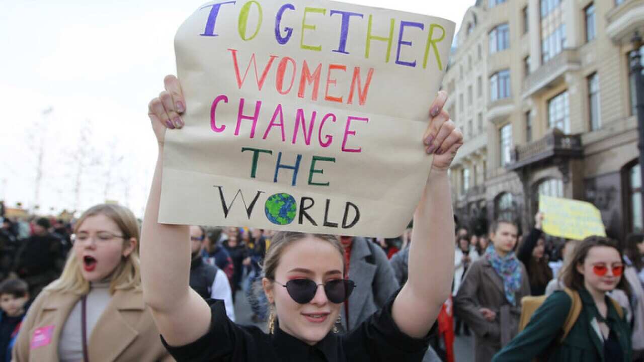 An activist at a Ukrainian protest march takes a stand against violence