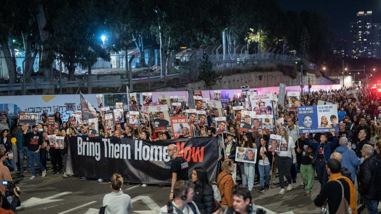 A group of protesters march through a street