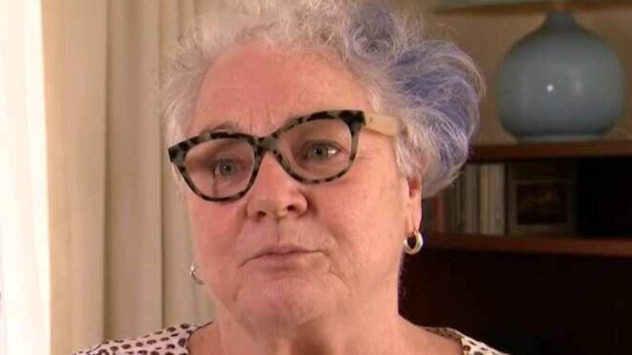 A woman wearing glasses sitting in a living room