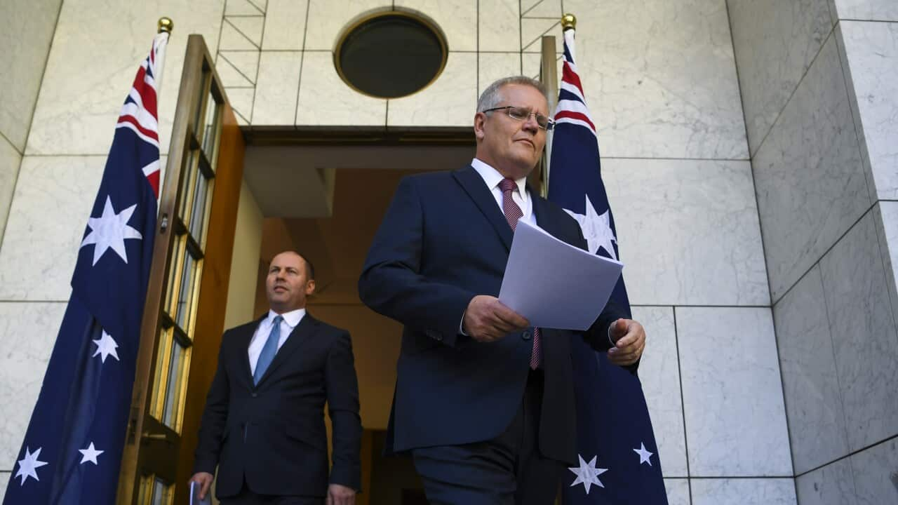 Australian Prime Minister Scott Morrison and Australian Treasurer Josh Frydenberg arrive to speak to the media during a press conference at Parliament House in Canberra, Friday, March 20, 2020. (AAP Image/Lukas Coch) NO ARCHIVING