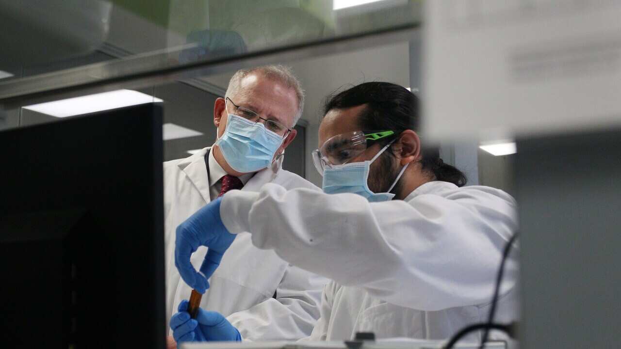 Prime Minister Scott Morrison meets with team member Gaby Atencio during a visit to AstraZeneca laboratories in Macquarie Park, Sydney on 19 August, 2020. 