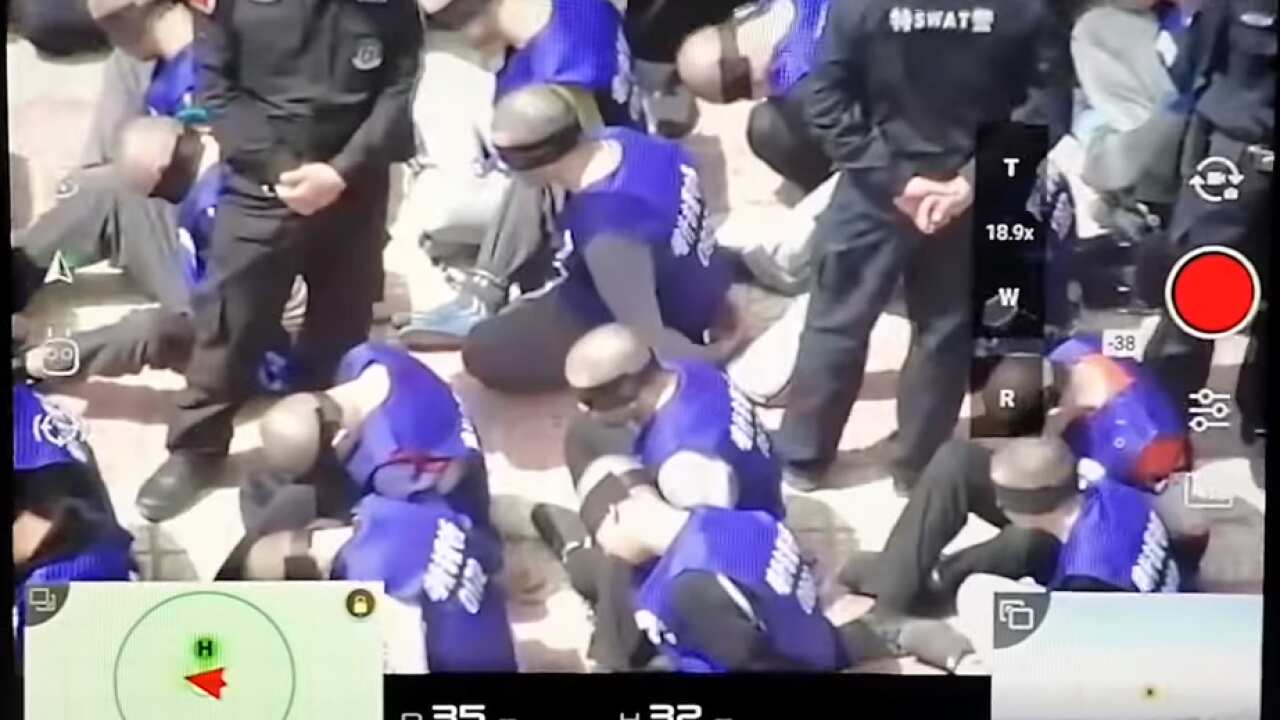 China footage reveals hundreds of blindfolded and shackled prisoners