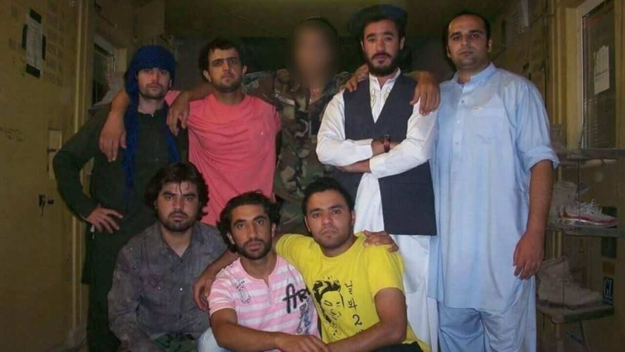 Ahmad* (centre), who was later killed because of his ties to the ADF, with other interpreters at the Uruzgan military base in Afghanistan.