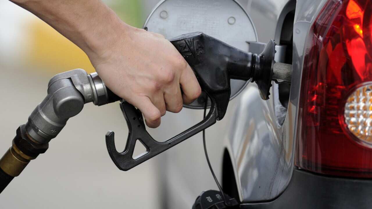 A person putting fuel into their car